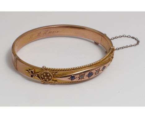 Victorian 9ct bloomed gold hinged bangle, inset with rose gold panel of sapphire and diamonds.  Hallmarked 9ct with inscripti