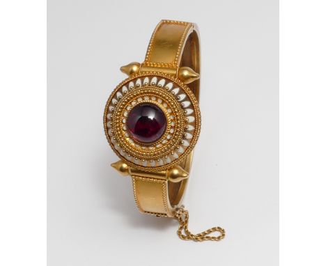 Good Victorian bangle in the Etruscan style of bloomed gold with central circular panel of white enamel within a granulated s