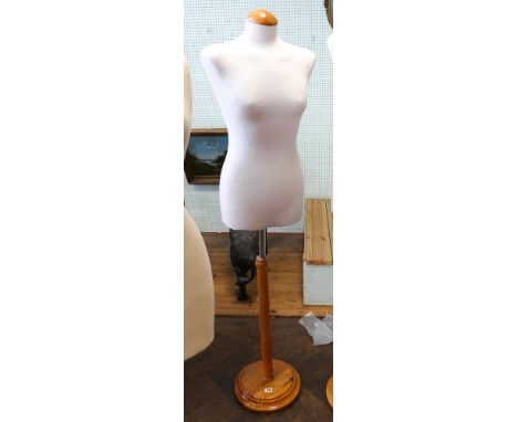 Half female shop mannequin on light oak stand 