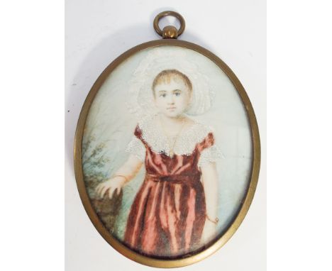 19th century portrait miniature on ivory of a girl wearing a red lace dress in oval brass frame approximately 8cm long 