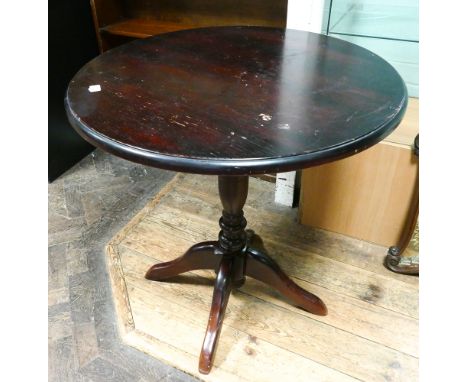 A circular stained oak pub style table on pillar base