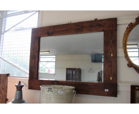A large pine framed bevel edge wall mirror