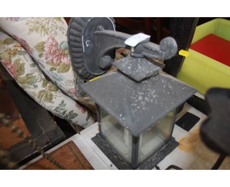 An outdoor metal and glass lamp 