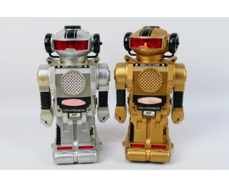 Tomy - An unboxed pair of vintage 2002 Tomy battery operated Model-B Robots. The robots made in Hong Kong by New Bright, show