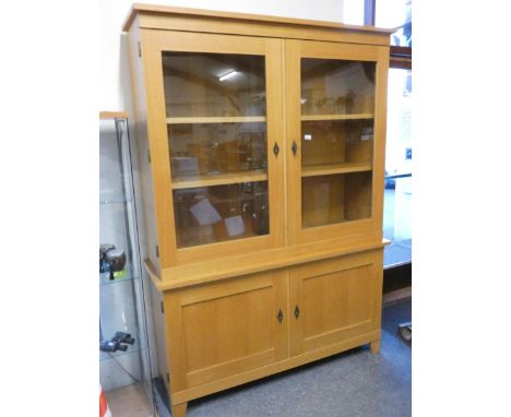 A light oak display cabinet with two glazed doors over two cupboard doors, 150 x 46 x 209 cm.