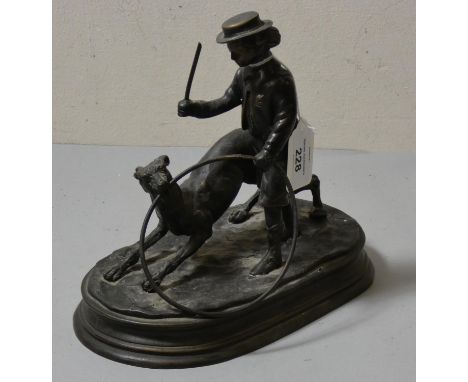 A bronzed figure of a boy with stick &amp; hoop and dog. 