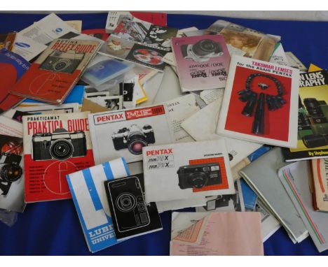 A collection of camera accessories, to include flash, a large quantity of camera manuals and slide projectors. 
