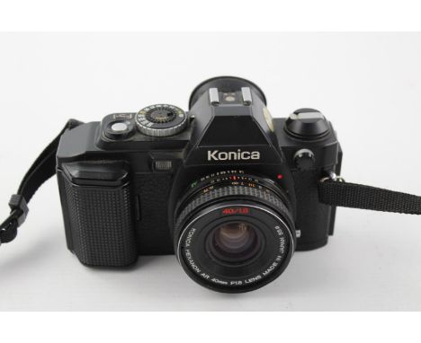 Konica FS-1 SLR Film Camera w/ Konica Hexanon AR 40mm F/1.8 Pancake Lens  The camera is WORKING and in a vintage condition Wi