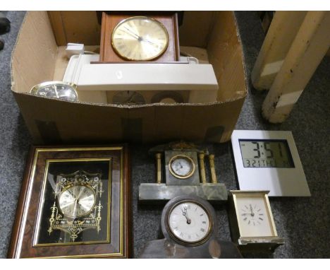 A collection of mantle clocks, carriage, and travel clocks, including a figurative brass table clock in the form of a fisherm