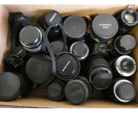 A collection of camera lens, to include Sigma convertor for video camera, Canon 50 Cosina 100-300, Hoya 55 skylight, Photax 2