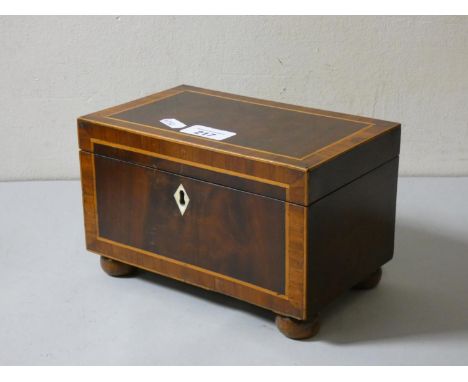A mohogany inlaid and cross banded tea caddy on raised bobbin feet. 