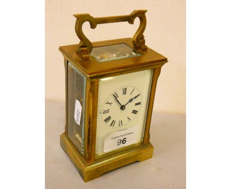 A brass cased manual wind carriage clock with white enamelled dial and Roman numerals, stamped ACG to the movement.12cm tall.