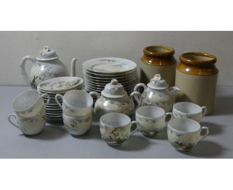 A Japanese hand painted fine porcelain tea service, comprising tea pot, sugar bowl, milk jug, 8 cups/12 saucers and 12 side p