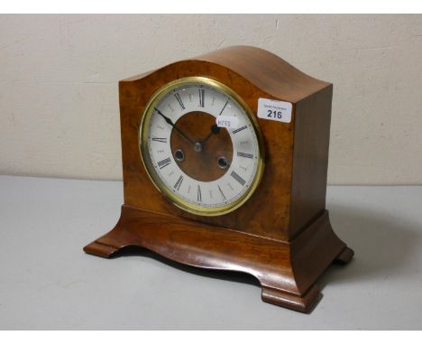 A walnut cased manual wind mantle clock. 