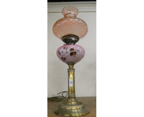 A brass column oil lamp with copper reservoir and etched glass shade. 