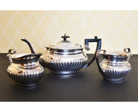 A SEMI FLUTED SILVER THREE PIECE TEA SET, comprising teapot, sugar basin and milk jug.London 1995.  Weight 44ozs.