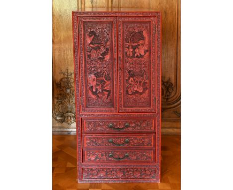 A GOOD CHINESE CARVED RED LACQUER STANDING CABINET, with double panel doors enclosing eight drawers, with four drawers below.