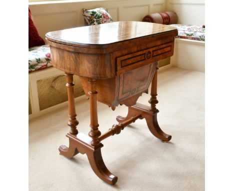 A GOOD VICTORIAN WALNUT GAMES AND SEWING STAND, the folding top opening to reveal backgammon, cribbage and chess, with a sewi