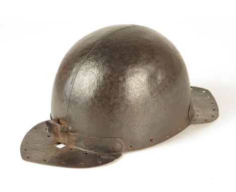 A 16th century helmet, constructed in two pieces with front and back peaks, with pierced holes, the front previously with a n