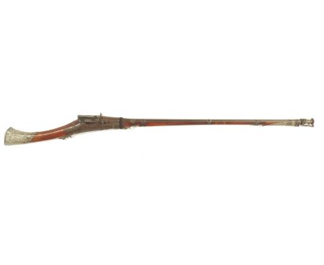 An Indian matchlock rifle, with a 108.5cm long barrel with a ribbed spool type end, with a hardwood full stock with silver co