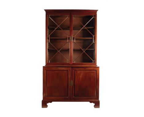 A George II mahogany bookcase cabinet, with a pair of astragal glazed doors enclosing three adjustable shelves, the base with