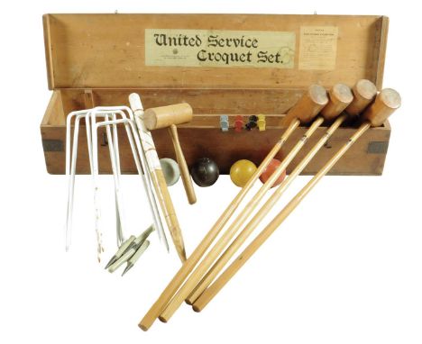 A United Service croquet set, in a pine box, with applied paper labels inscribed 'Army & Navy Co-operative Society, W10, 105 