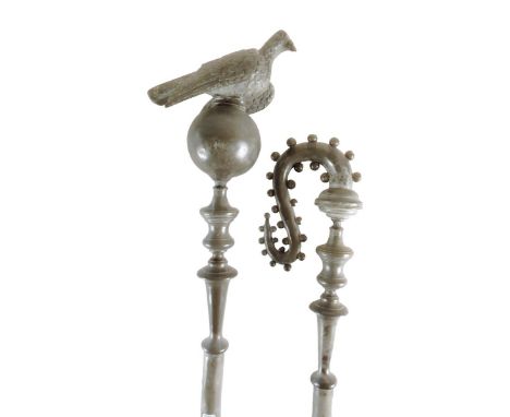 Two continental pewter sceptres, one with a dove and orb finial, the other of scroll form with prunts, each with an ebonized 