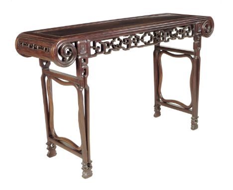 A Chinese padouk altar table, the panelled top above a scroll and pierced fret frieze, on open supports, early 20th century, 