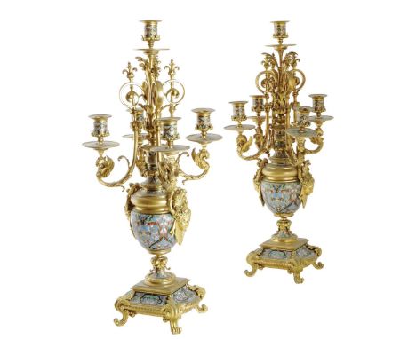 A pair of late 19th century French ormolu and champlevé enamel five light candelabra, decorated with griffin scroll arms and 