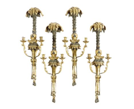 A set of four French twin light wall appliques, each with a palm tree backplate above a seated blackamoor figure playing a tr