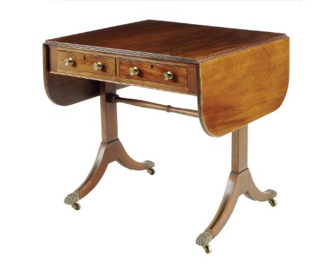 An early 19th century mahogany sofa table, inlaid with ebonized stringing, the reeded edge drop-leaf top above a pair of ceda