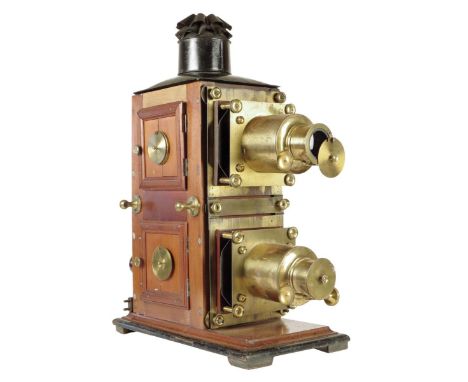 A late Victorian mahogany and gilt brass biunial magic lantern, with two projector lenses with rack and pinion focusing, with