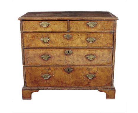 An early 18th century walnut chest, the cross and feather banded quarter veneered above two short and three long drawers and 