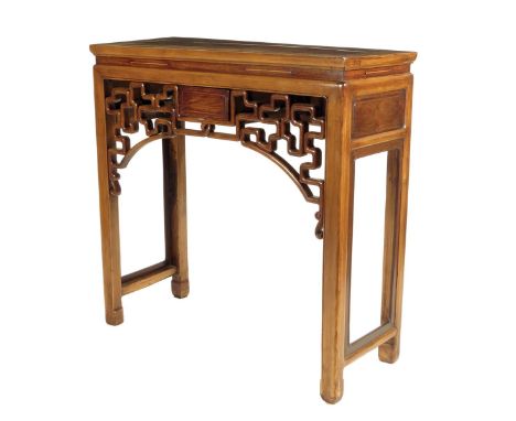 A Chinese hardwood side table, the panelled top above a pierced fret frieze, with open supports and scroll feet. 94.4cm high,