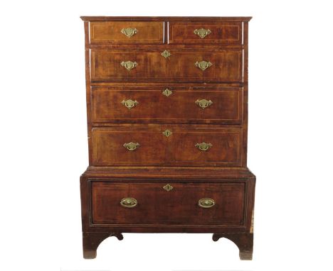 A George II walnut chest on stand, with two short and four long drawers inlaid with holly stringing, with stained pine and oa