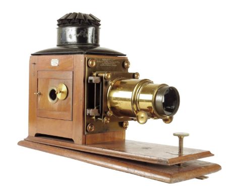A mahogany and gilt brass magic lantern by Newton & Co., with a rack and pinion focusing, a black metal chimney and a single 