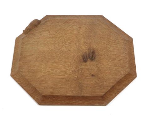 Workshop of Robert Mouseman Thompson (Kilburn): An English Oak Bread Board, of canted rectangular shape, with carved mouse tr