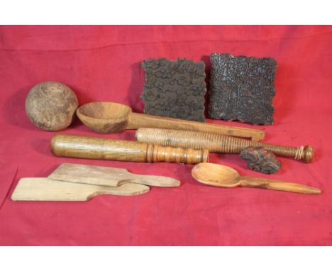 An old wicker basket containing two turned wooden truncheons, two printing blocks, a wooden ladle etc.