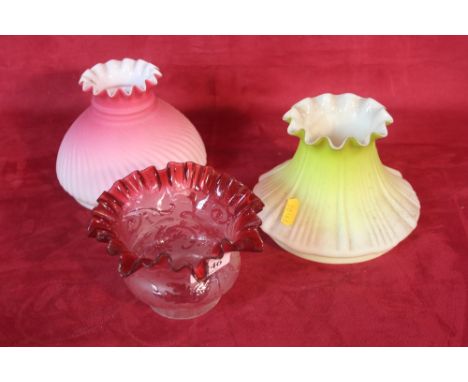 A Victorian ruby tinted oil lamp shade with frilled rim and two similar period opaque glass oil lamp shades