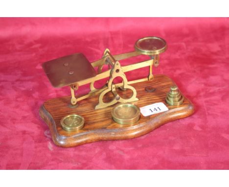 A set of brass postal scales and weights 