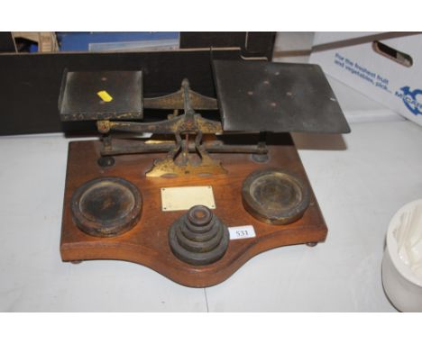 A large set of postal scales with seven brass weights 