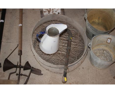 Two vintage soil sieves; a brass garden sprayer and an enamel jug
