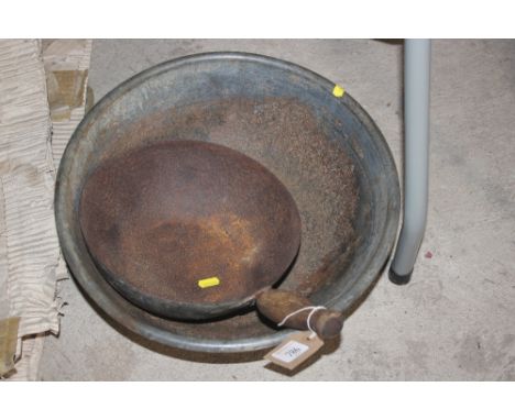A metal ware hand basin and a feed scoop with a wooden handle
