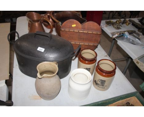 An old iron cooking pot, Bourton-on-the-Water pottery milk jug; three storage jars and a heart shaped spoon rack