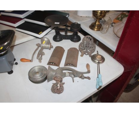 A set of cast iron kitchen scales; two old mincers; graters; hearth trivet etc.