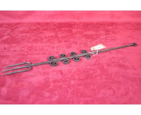 An antique iron toasting fork