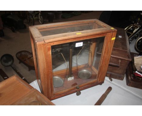 A set of laboratory scales in glazed wooden case 