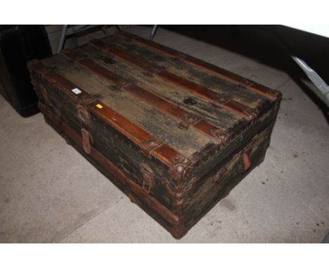 A wooden and metal bound steamer trunk