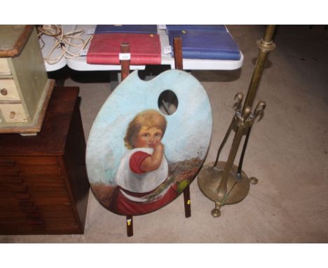 A firescreen in the form of a painted artists pallet and easel 