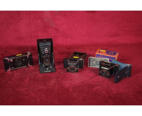A No.2 folding film pack Hawk-eye (No.520) camera No.20488; a Ensignette No.2 Houghtons Ltd camera; An Ensign midget camera a